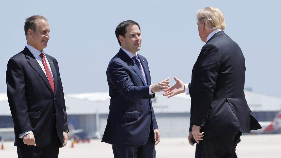 President Donald Trump is greeted by Sen. Marco Rubio, R-Fla., as Hialeah Mayor Carlos Hernandez, left, and Rep. Mario Diaz-Balart, R-Fla., look on during Trump’s arrival on Air Force One at Miami International Airport, Monday, April 16, 2018. Miami-Dade Mayor Carlos Gimenez had wanted to join the welcoming party, but he was not invited.