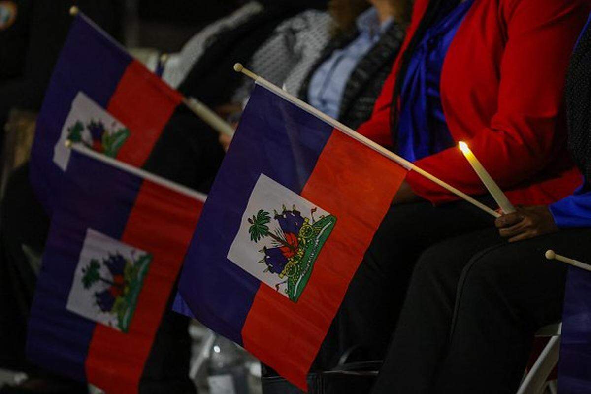 People attend a candlelight vigil for Haitians living in the US under the Temporary Protected Status (TPS) immigration program in Miami, Florida on February 3, 2026. Late on February 2, federal judge Ana C. Reyes of the Federal District Court in Washington, blocked the Trump administration from ending TPS for an estimated 350,000 Haitian immigrants. The status, which offers protection from deportation and work authorization, was set to expire on Feb. 3. (Photo by Giorgio Viera / AFP via Getty Images)