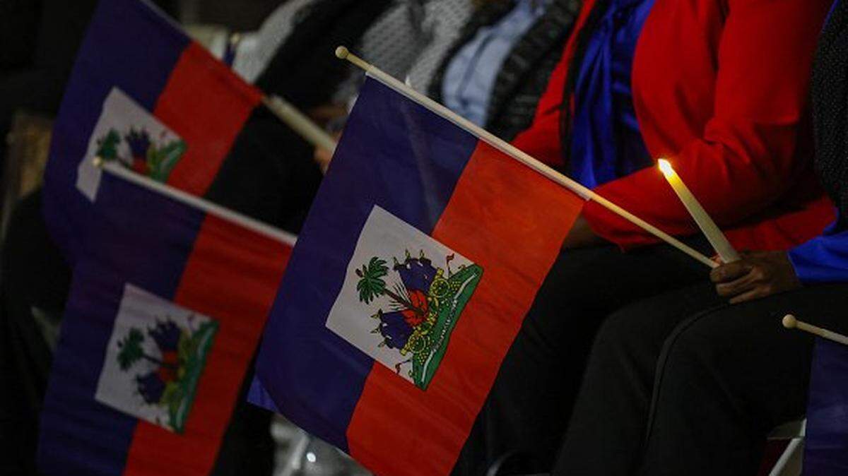 People attend a candlelight vigil for Haitians living in the US under the Temporary Protected Status (TPS) immigration program in Miami, Florida on February 3, 2026. Late on February 2, federal judge Ana C. Reyes of the Federal District Court in Washington, blocked the Trump administration from ending TPS for an estimated 350,000 Haitian immigrants. The status, which offers protection from deportation and work authorization, was set to expire on Feb. 3. (Photo by Giorgio Viera / AFP via Getty Images)