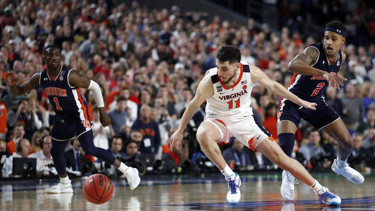 Virginia guard Ty Jerome (11) runs down a loose ball ahead of Auburn guard Bryce Brown, right, during the second half in the semifinals of the Final Four NCAA college basketball tournament, Saturday, April 6, 2019, in Minneapolis.