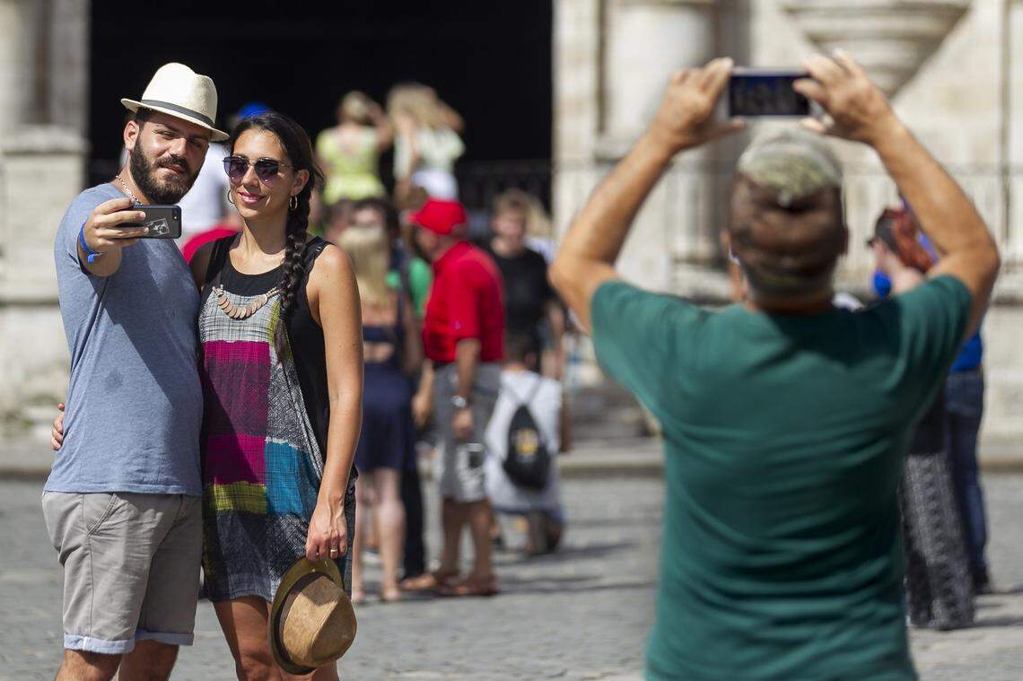 Walter Maruca, 25, left, and Donatella Mirabeli, 23, tourists from Italy, take selfies in Old Havana, Cuba.