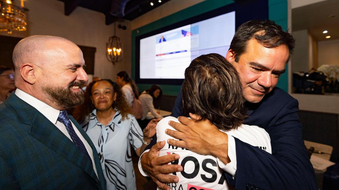 Ralph Rosado, right, hugs his mother after an win during Rosado’s watch party on Tuesday, June 3, 2025, at El Atlacatl restaurant in Miami. Commissioners Damian Pardo and Christine King are pictured at left.