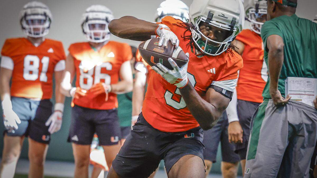 Miami Hurricanes wide receiver Joshua Moore (3) runs through practice drills with teammates at the Carol Soffer Indoor Practice Facility in Coral Gables, Florida, on Thursday, July 31, 2025.