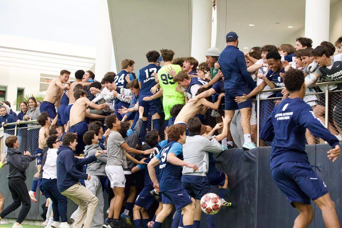 Gulliver boys’ soccer players jump into the stands to celebrate with their fans on Tuesday after beating JC Bermudez in penalty kicks in a Region 4-3A quarterfinal at Gulliver.