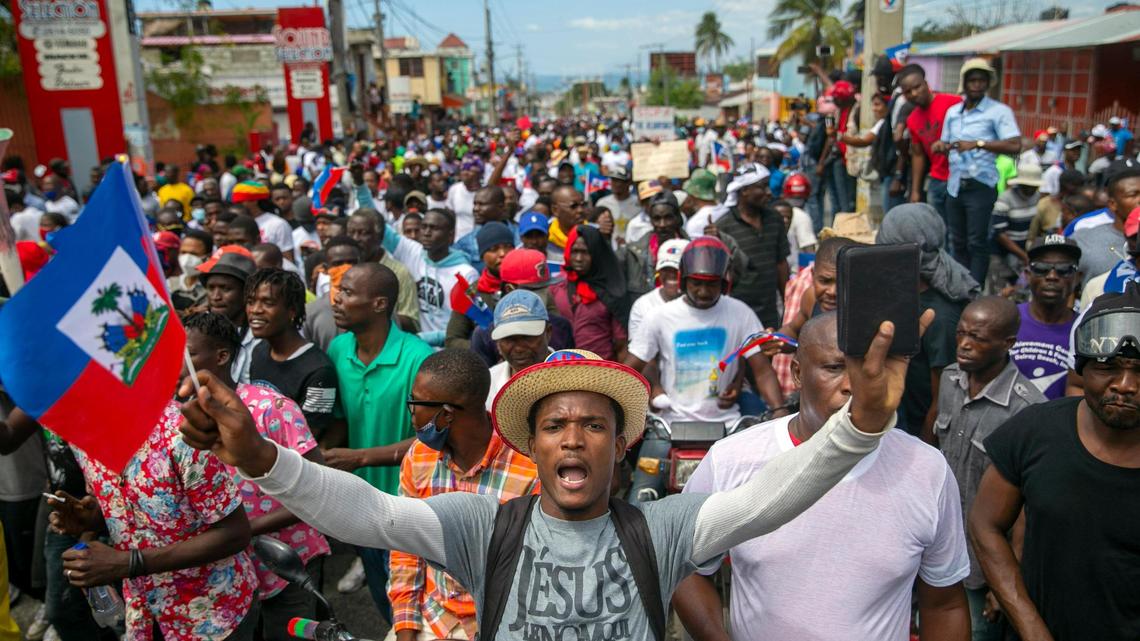 People protest to demand the resignation of Haitian President Jovenel Moise in Port-au-Prince, Haiti, Sunday, Feb. 28, 2021. The opposition is disputing the mandate of President Moise whose term they claim ended on Feb. 7, but the president and his supporters say his five-year term only expires in 2022.