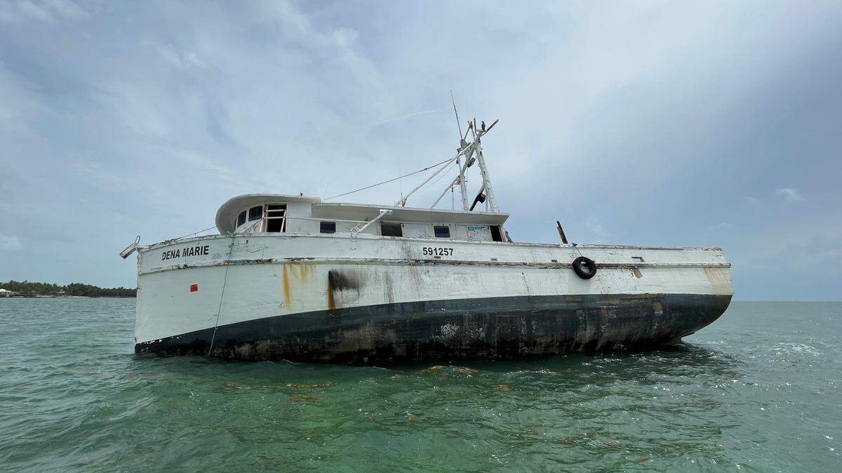 A 53-foot vessel lists grounded on a sandbar in Bahia Honda State Park in the Florida Keys. It is one of hundreds of boats removed from Monroe County waters in 2025.
