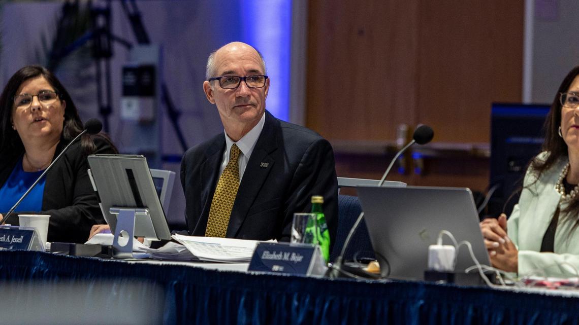 Flanked by Aime Martinez, left, and Elizabeth M. Bejar, Interim President of FIU Kenneth Jessell listens to someone speak during an FIU Board of Trustees meeting held at the FIU Modesto A. Maidique Campus in Miami on Thursday, March 3, 2022.