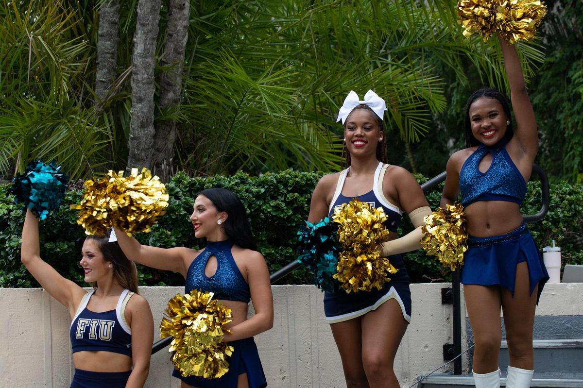 FIU cheerleaders wave during a toast to celebrate FIU’s 50th anniversary on the steps of the Charles Perry Building at the Modesto A. Maidique Campus in Miami, Fla., on Monday, Sept. 19, 2022.