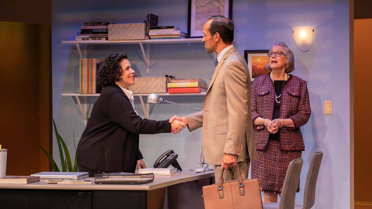 Carmen Pelaez as Camila greets Phillip Hernandez as an independent art dealer while Carole Monferdini as her boss looks on in the Miami New Drama world premiere of ‘Fake.’