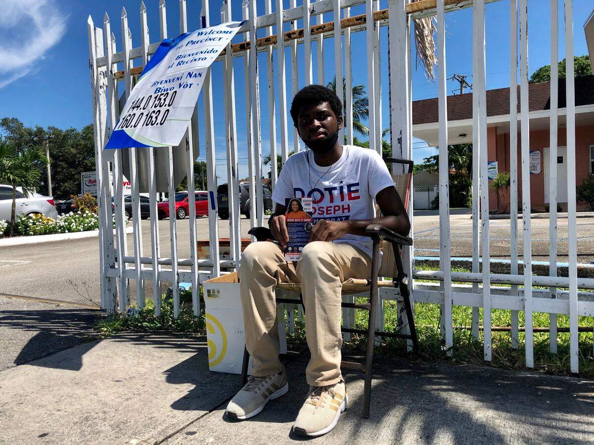 Evans Vertus, 21, sits outside Stanton Memorial Baptist Church in North Miami during Tuesday’s primary. He was supporting Florida House candidate Dotie Joseph on Aug. 18, 2020.