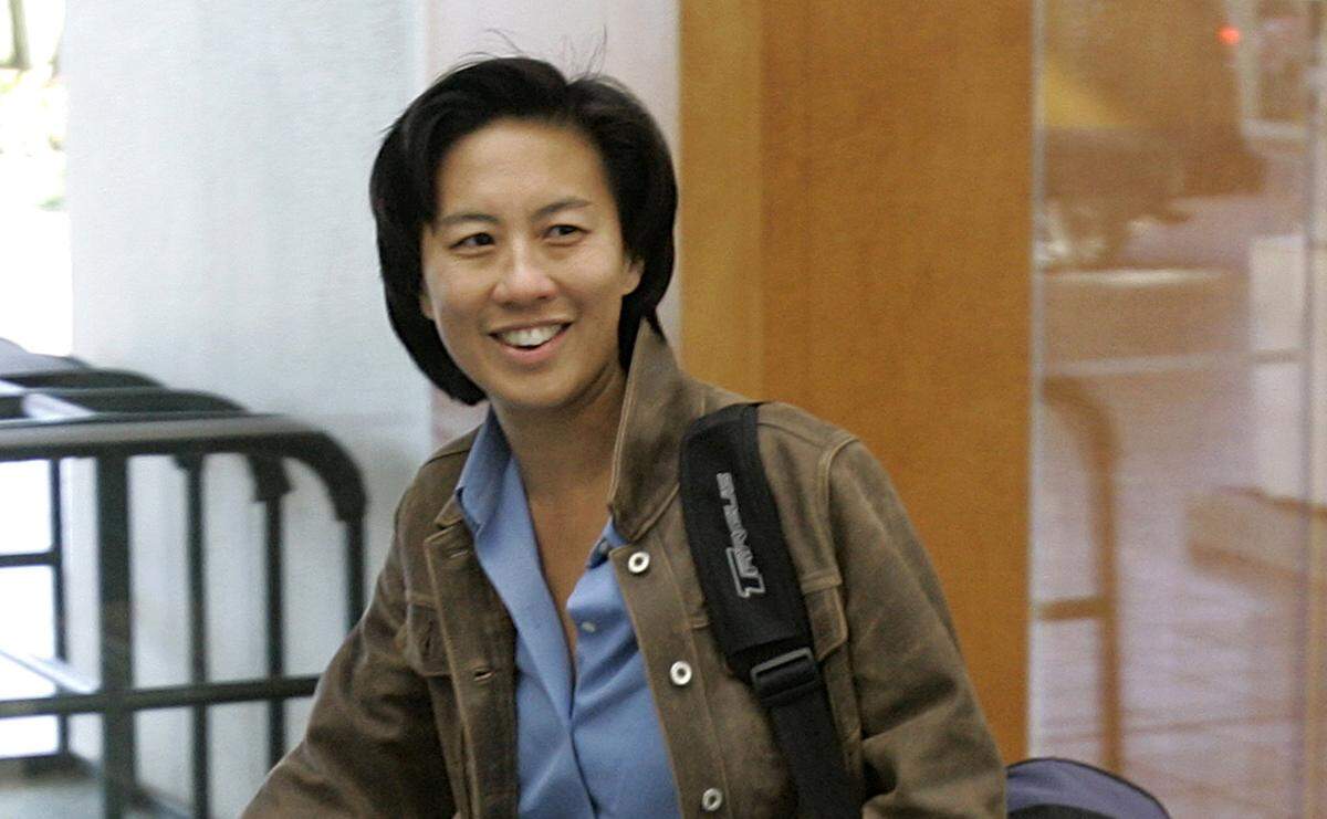 In this Nov. 5, 2007, file photo, then-Los Angeles Dodgers assistant general manager Kim Ng walks through the hotel lobby during the first day of Major League Baseball annual general managers meetings in Orlando, Fla.