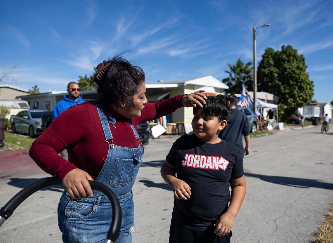 Martha Torres, and her grandson, Jacobo Cardozo Yate, 10, attend a protest near one of the entrances to the Li’l Abner Mobile Home Park on Saturday, Dec. 21, 2024, in Sweetwater, Florida. All 900-plus mobile homeowners were notified by the park’s owner, CREI Holdings, that the park will permanently close on May 19, and residents must vacate the premises by then, with or without their homes.