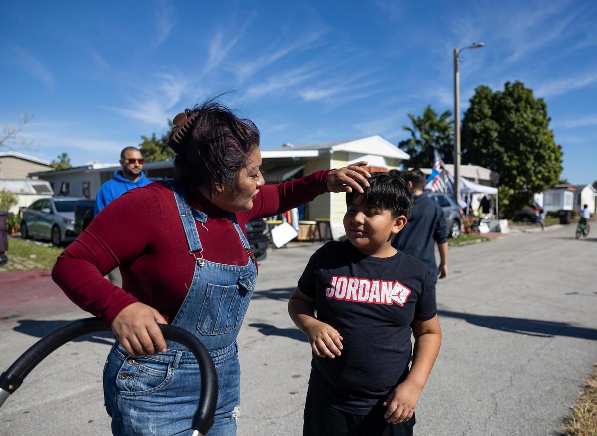 Martha Torres, and her grandson, Jacobo Cardozo Yate, 10, attend a protest near one of the entrances to the Li’l Abner Mobile Home Park on Saturday, Dec. 21, 2024, in Sweetwater, Florida. All 900-plus mobile homeowners were notified by the park’s owner, CREI Holdings, that the park will permanently close on May 19, and residents must vacate the premises by then, with or without their homes.