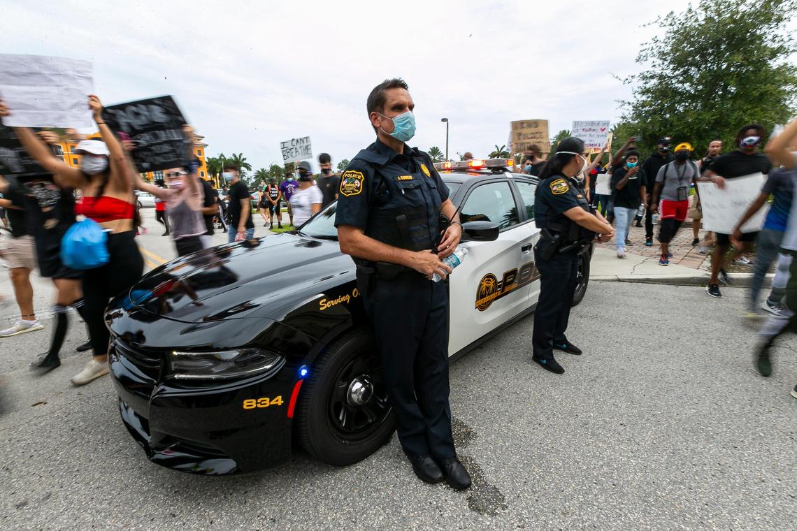 Miramar Police watch as hundreds of protestors make their way toward their headquarters and city hall during a Justice for George Floyd rally in Miramar, Florida on Saturday, June 6, 2020. Hundreds of protestors took to the street Saturday protesting against police brutality and the death of George Floyd in Minneapolis.