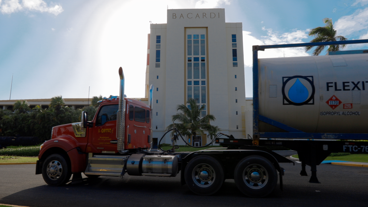 A cargo truck stationed in front of the Bacardi rum factory in Puerto Rico.