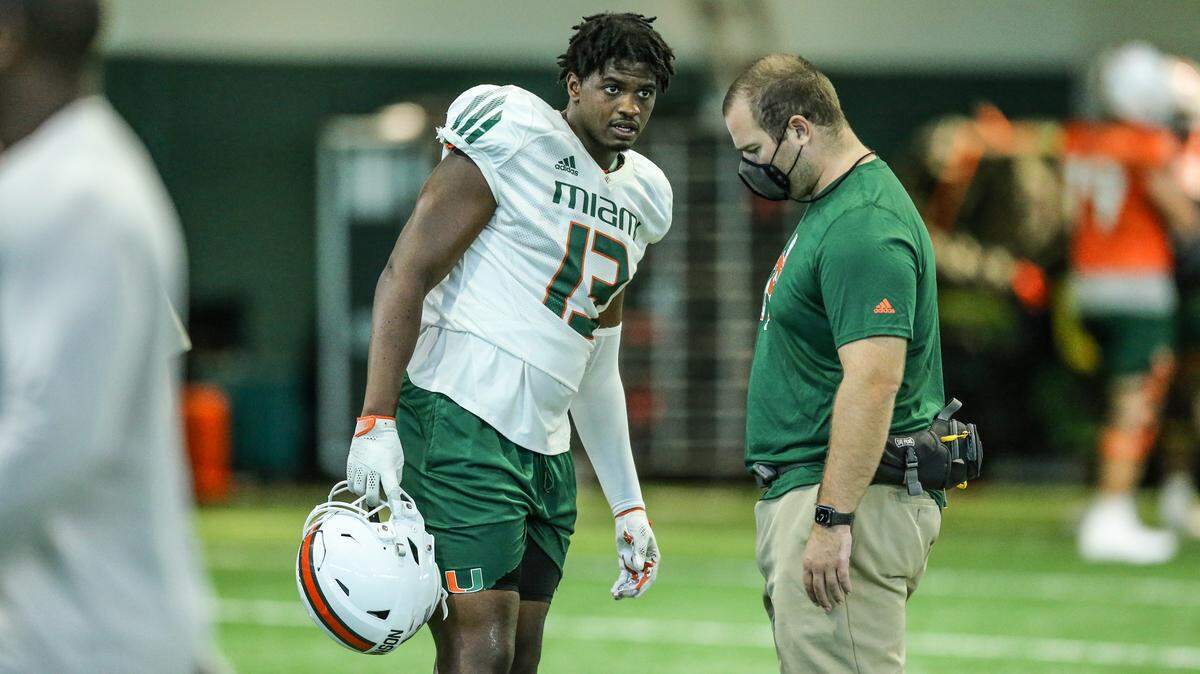 Miami Hurricanes defensive end Deandre Johnson (13) looks on during practice at the University of Miami’s Carol Soffer Indoor Practice Facility in Coral Gables on Tuesday, August 10, 2021.