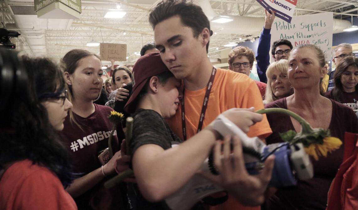 David Hogg hugs a fellow protester after the 12-minute demonstration ended inside the store. Protesters spread out on the floor of the Publix store in Coral Springs Friday, May 25, 2018, for a 12 minute "die-in" to protest Publix's support for Adam Putnam's gubernatorial campaign.