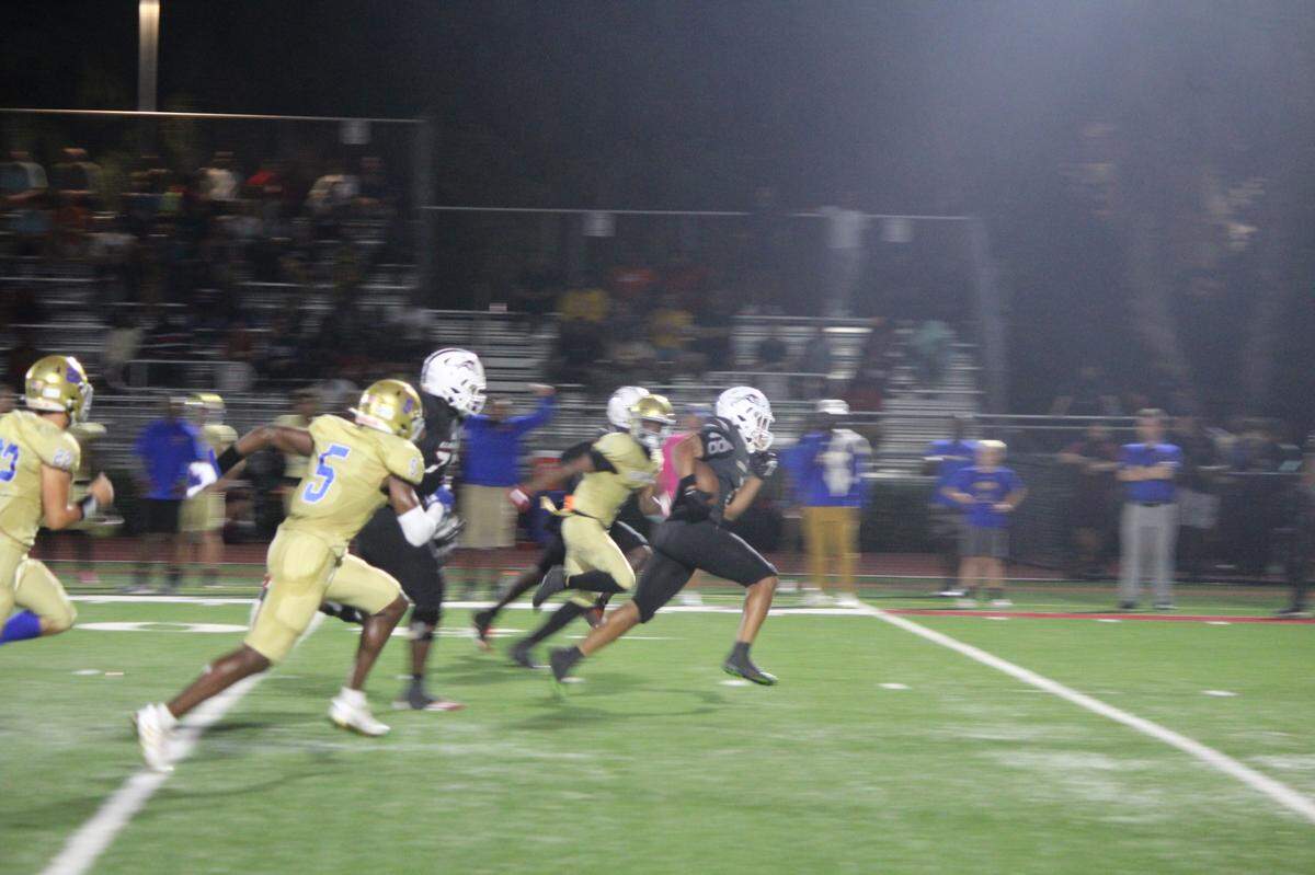 With Cardinal Newman defenders in pursuit, Chaminade running back Davion Gause takes off on a 44-yard second quarter touchdown run.