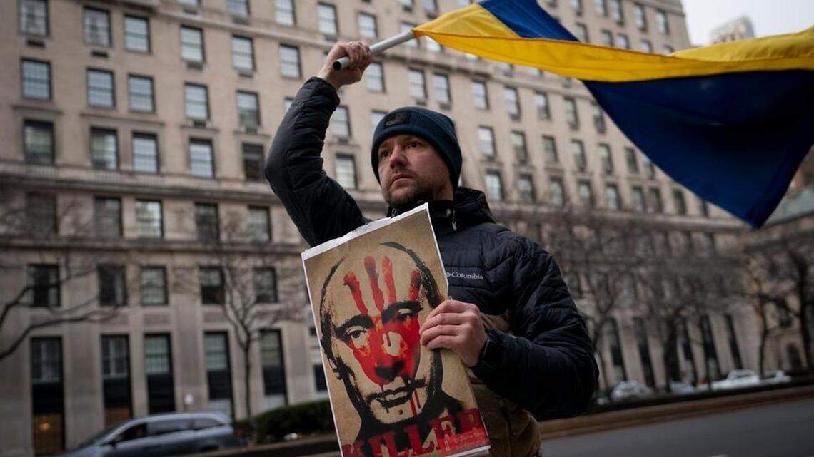 A man in New York protests the Russian invasion of Ukraine. The BBB compiled a list of tips on how to avoid falling for scams when looking for relief organizations that support Ukraine.