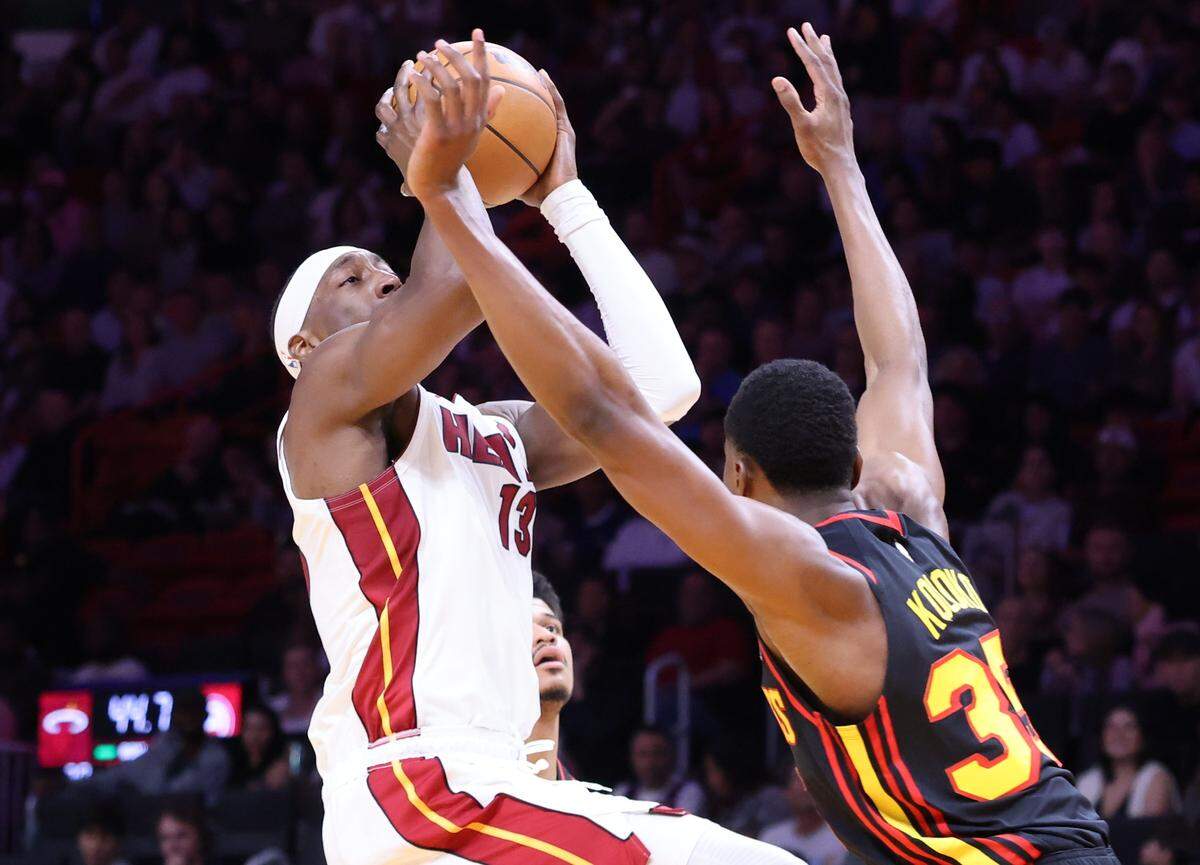 Heat center/forward Bam Adebayo, left, takes the shot over Hawks Christian Koloko during the first half of Heat vs. Hawk in the last game of the regular season inside the Kaseya Center on Sunday, April 12, 2026 in Miami, Florida.