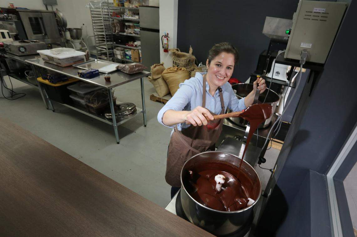 Exquisito Chocolates is opening Miami's first chocolate factory in Little Havana. Owner Carolina Quijano stirs chocolate in the melanger, a machine that conches and refines the chocolate.
