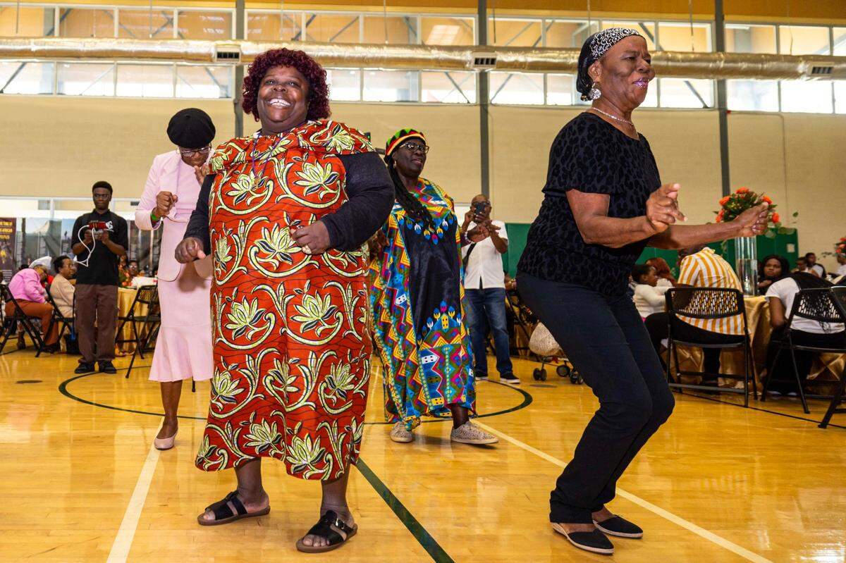 Women dance to the music during the 18th Annual Haitian Thanksgiving Brunch.