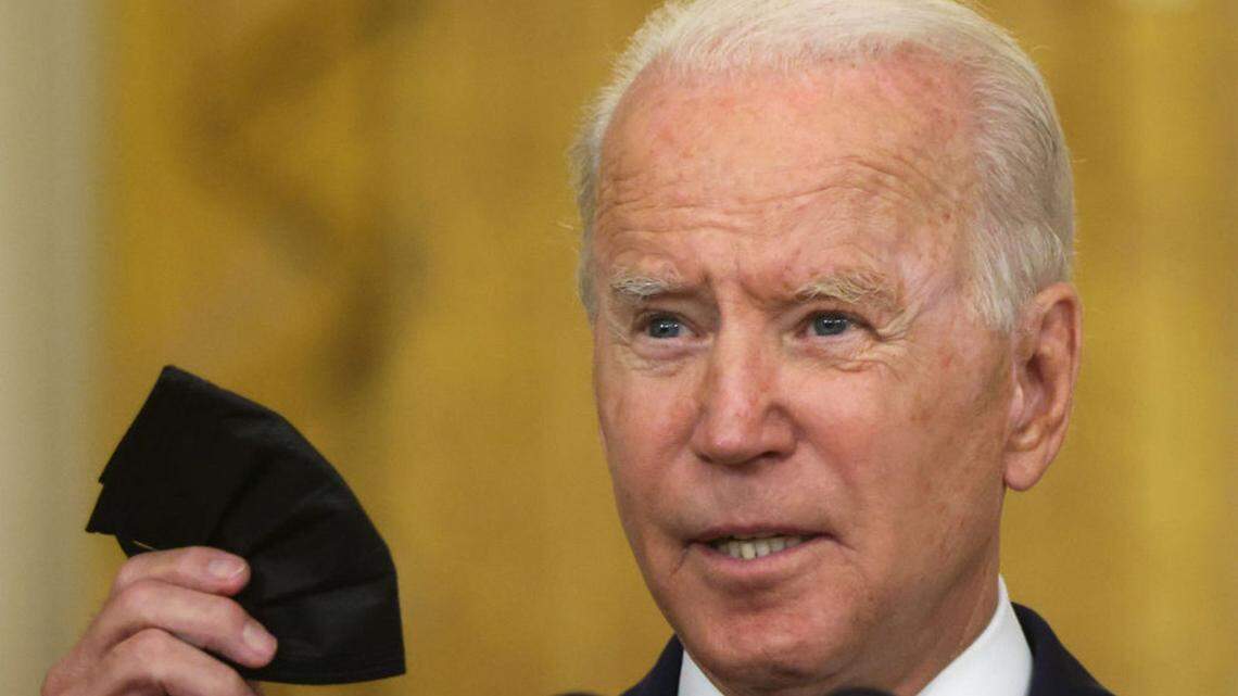 U.S. President Joe Biden holds up a mask during an event on Senate passage of the Infrastructure Investment and Jobs Act in the East Room of the White House August 10, 2021 in Washington, DC. The Senate has passed the bipartisan infrastructure bill with a vote of 69-30. (Alex Wong/Getty Images/TNS)