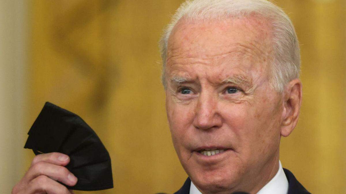 U.S. President Joe Biden holds up a mask during an event on Senate passage of the Infrastructure Investment and Jobs Act in the East Room of the White House August 10, 2021 in Washington, DC. The Senate has passed the bipartisan infrastructure bill with a vote of 69-30. (Alex Wong/Getty Images/TNS)
