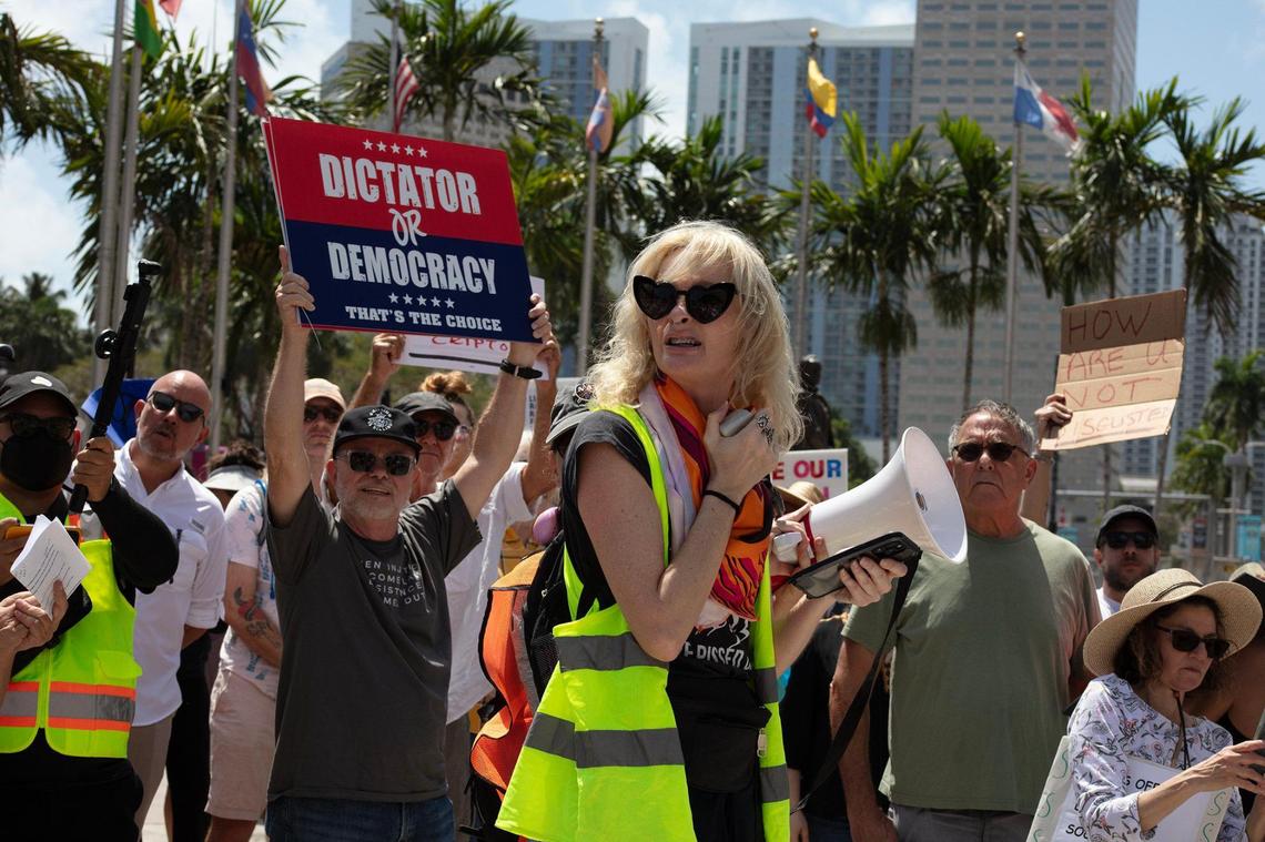 Kat Duesterhaus talks as she ttakes part in the “Hands Off! Miami Fights Back” rally against the policies of President Donald Trump and his Senior Advisor Elon Musk, on Saturday, April 5, 2025, at the Torch of Friendship in Miami, Florida.