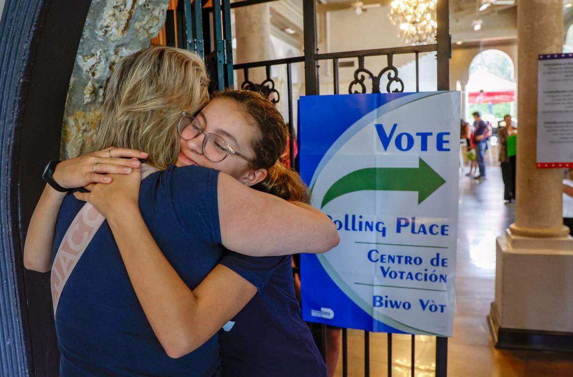 After getting a tour of voting precincts 601and 608, Elizabeth Reyes, 12, hugs her mother Christine Reyes at the Coral Gables Country Club during Election Day in Coral Gables, Florida on Tuesday, November 5, 2024. Elizabeth, served as a poll worker during a mock election at her school at Henry S. West Laboratory School.