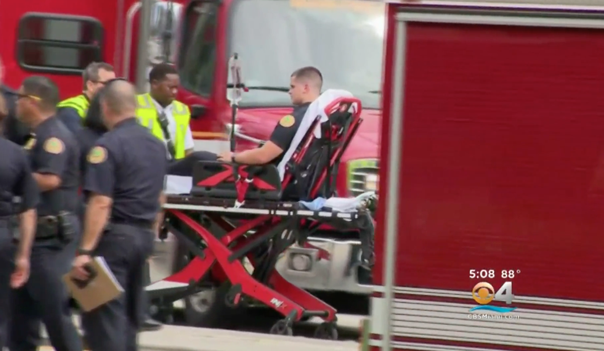 Miami police officer Jordany Bahamonde is transported to Jackson Memorial Hospital with minor injuries after a suspect, fleeing police in a stolen car, slammed into his cruiser on U.S. 1 near 17th Avenue on Sept. 11, 2018.