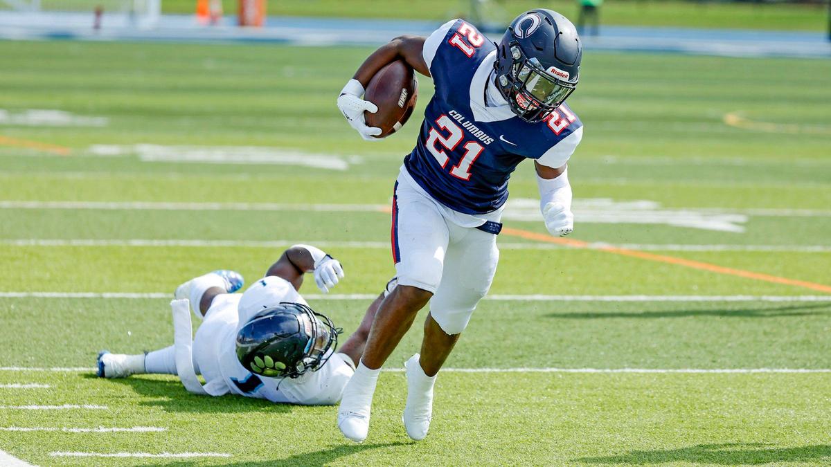 Columbus High School running back Agyeman Addae (21) breaks tackles on his way to a first down in the first half against Palmetto High School at Tropical Park Stadium in Miami, Florida on Saturday, September 16, 2023.