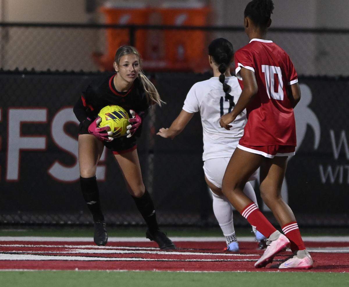 Cardinal Gibbons’ goalkeeper Kennedy McCausland (left) controls the ball during a recent match.