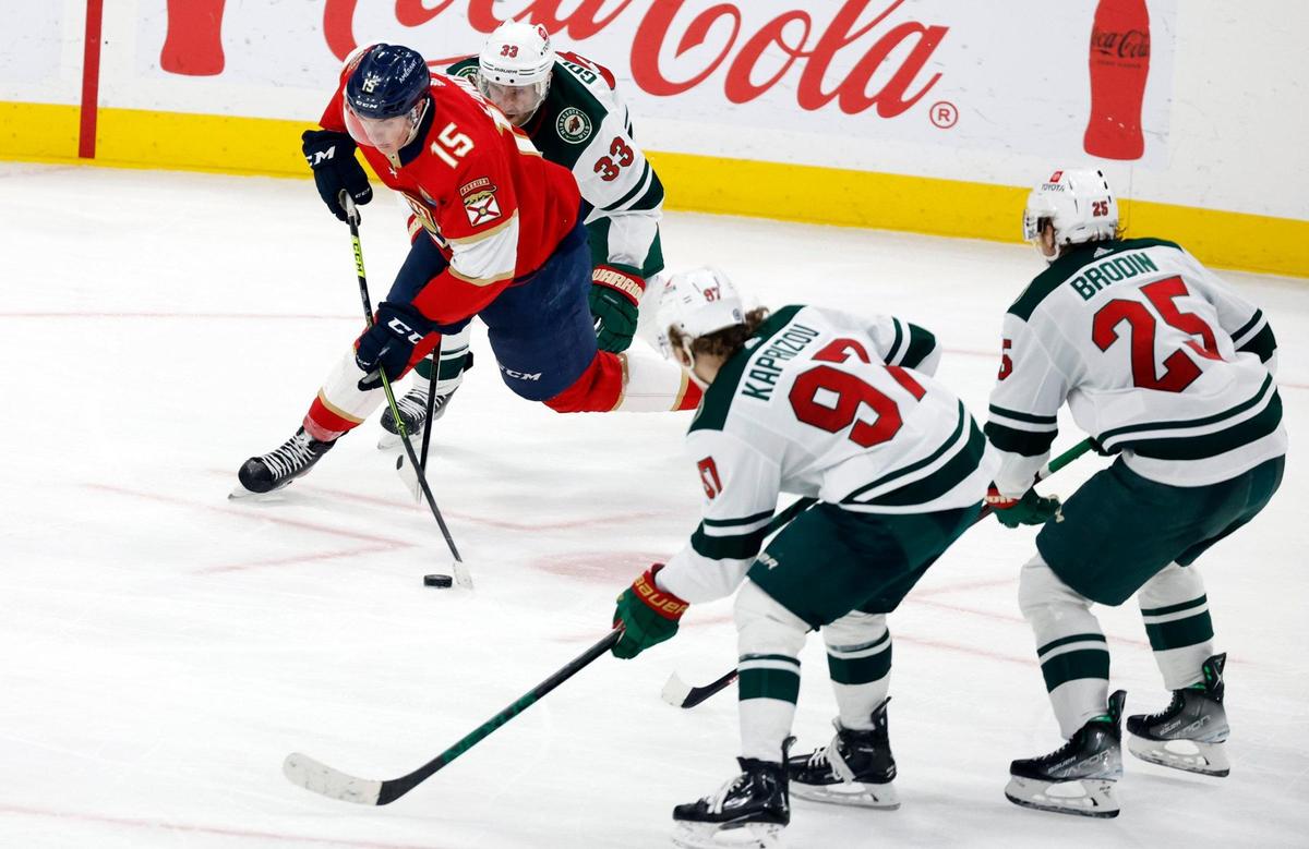 Florida Panthers center Anton Lundell (15) battles Minnesota Wild defenseman Alex Goligoski (33) in the third period at FLA Live Arena in Sunrise, FL on Saturday, January 21, 2023.