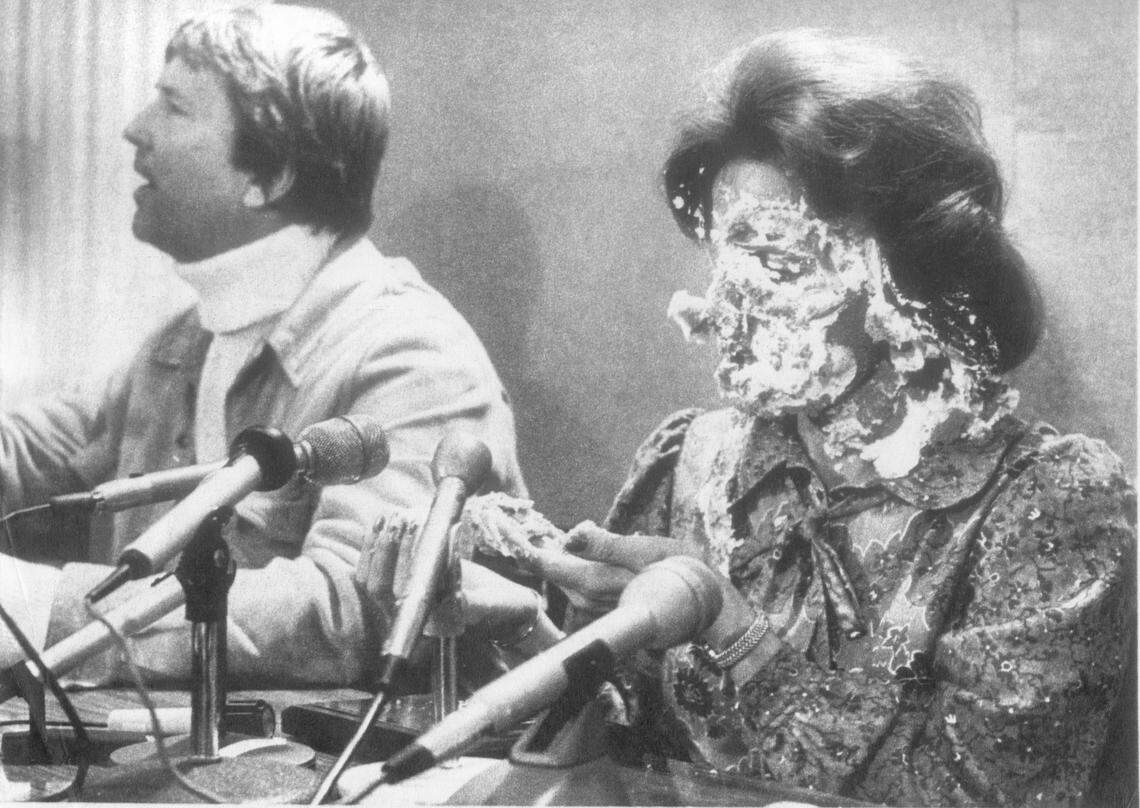Anita Bryant, her face covered with banana cream pie, stares in disbelief during a news conference when a man posing as a reporter jumped up and hit her in the face with a pie, Oct. 14, 1977. At left, Bryant’s husband, Bob Green. She was in Des Moines for a religious concert.