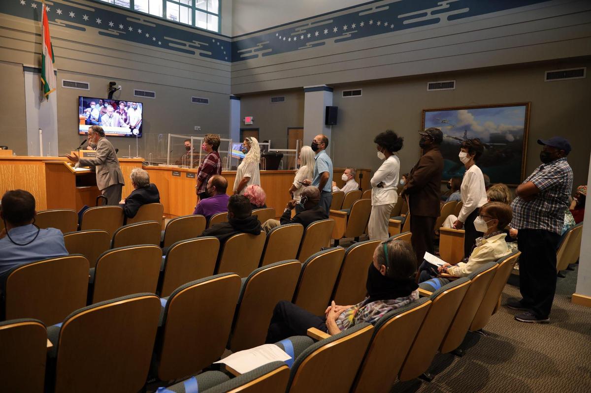 Grove resident Albert Gomez, left, gives his remarks during the public comment session as others line up to speak. Holland & Knight attorney and consultant Miguel De Grandy presented the preliminary redistricting plan in hope of balancing the population of each district during a special commission meeting at City Hall on Monday, Feb. 7, 2022.