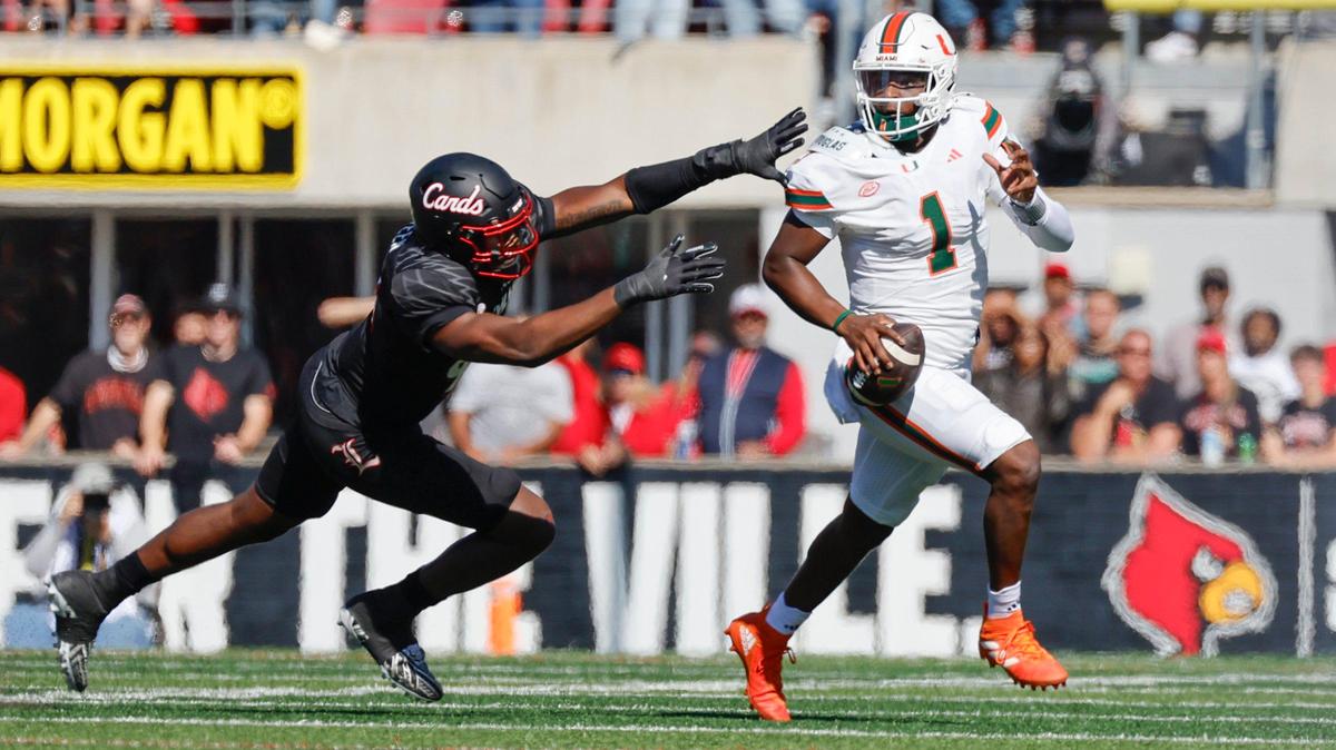 Miami Hurricanes quarterback Cam Ward (1) scrambles in backfield as Louisville Cardinals defensive lineman Adonijah Green (98) gives chase in first half during NCAA football game at L&N Federal Credit Union Stadium in Louisville, Kentucky on Saturday, October 19, 2024.