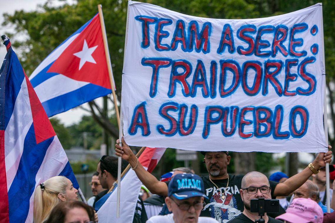 MIAMI, FL- March 19, 2023 - Demonstrators hold signs and shout slogans to protest the the game between the United States and Cuba in front of loanDepot Park prior to the baseball game.