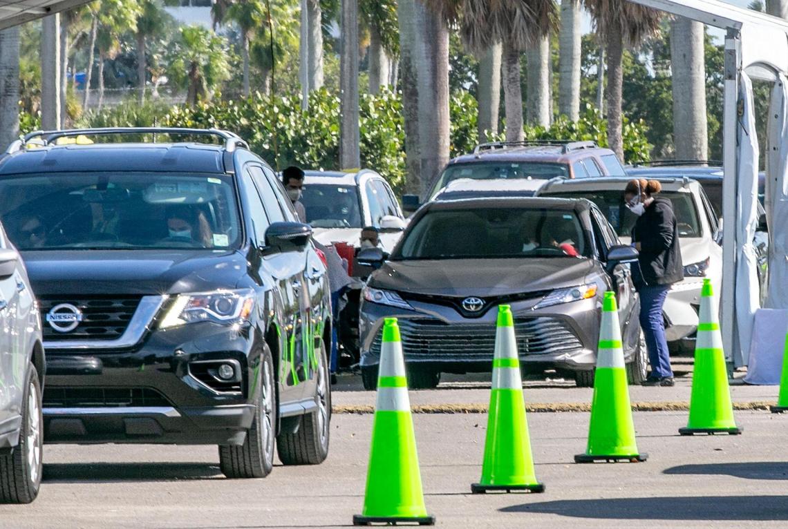 Long lines of cars are seen as people with appointments get the COVID vaccine at Tropical Park Covid test site.The Florida Highway Patrol and Miami-Dade Police urged drivers to avoid a portion of Bird Road because large crowds hoping to get the COVID-19 vaccine at the park is leading to traffic jams, as Coronavirus numbers surge in Miami-Dade County, on Saturday, January 09, 2021.