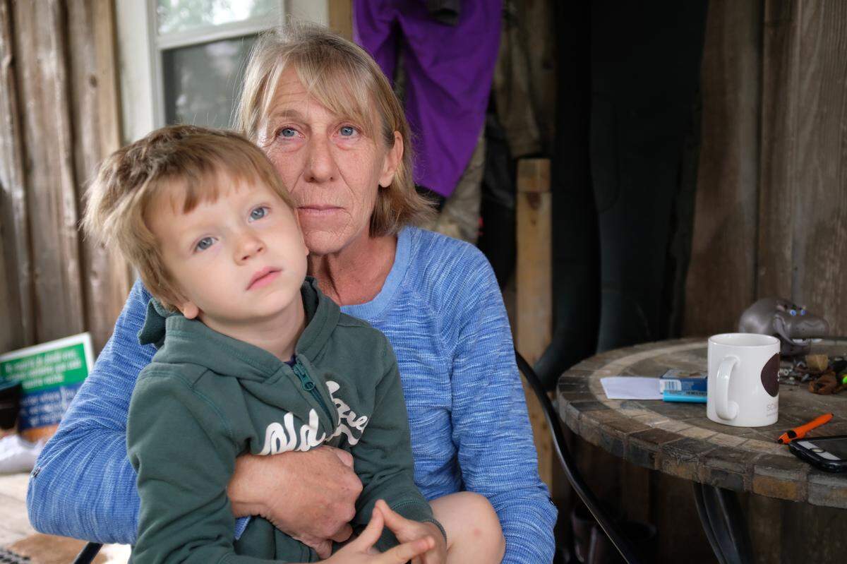 Laura Adams, a seafood harvester in Cedar Key, with her grandson, has seen surprising changes in the waters around her island city.