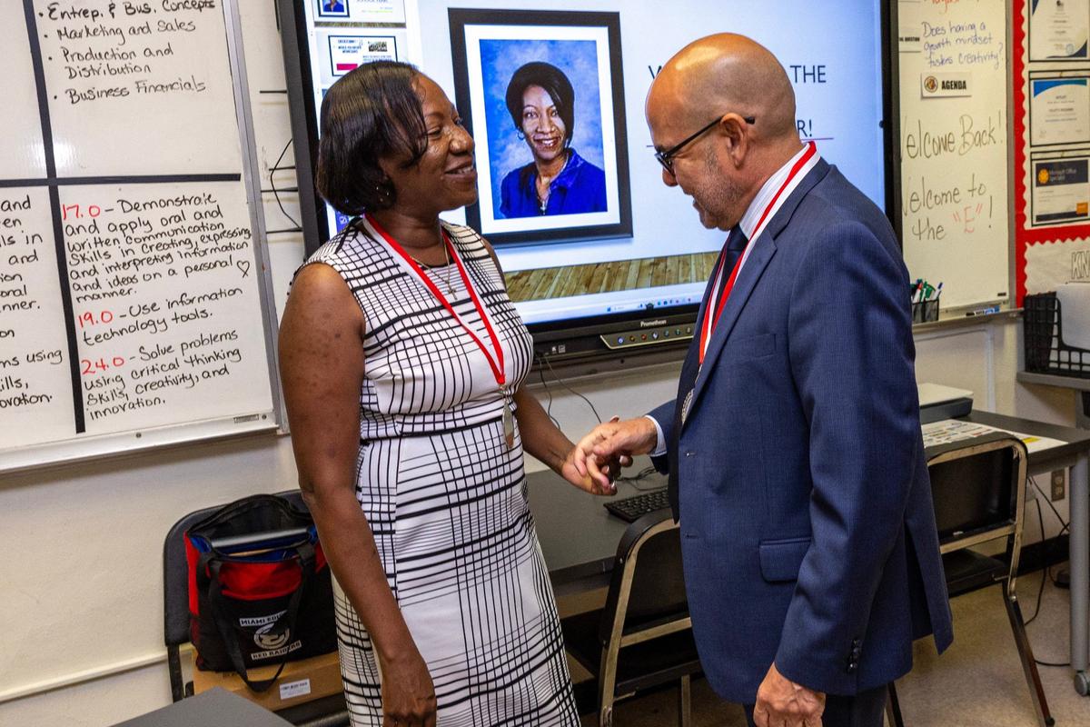 Superintendent Jose L. Dotres chats with accounting teacher Ms. Mezadieu at Miami Edison High.