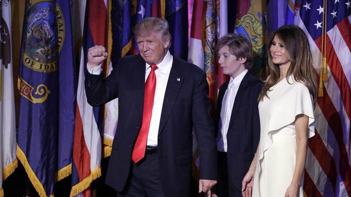 Barron Trump, 10, and his parents Donald and Melania Trump/