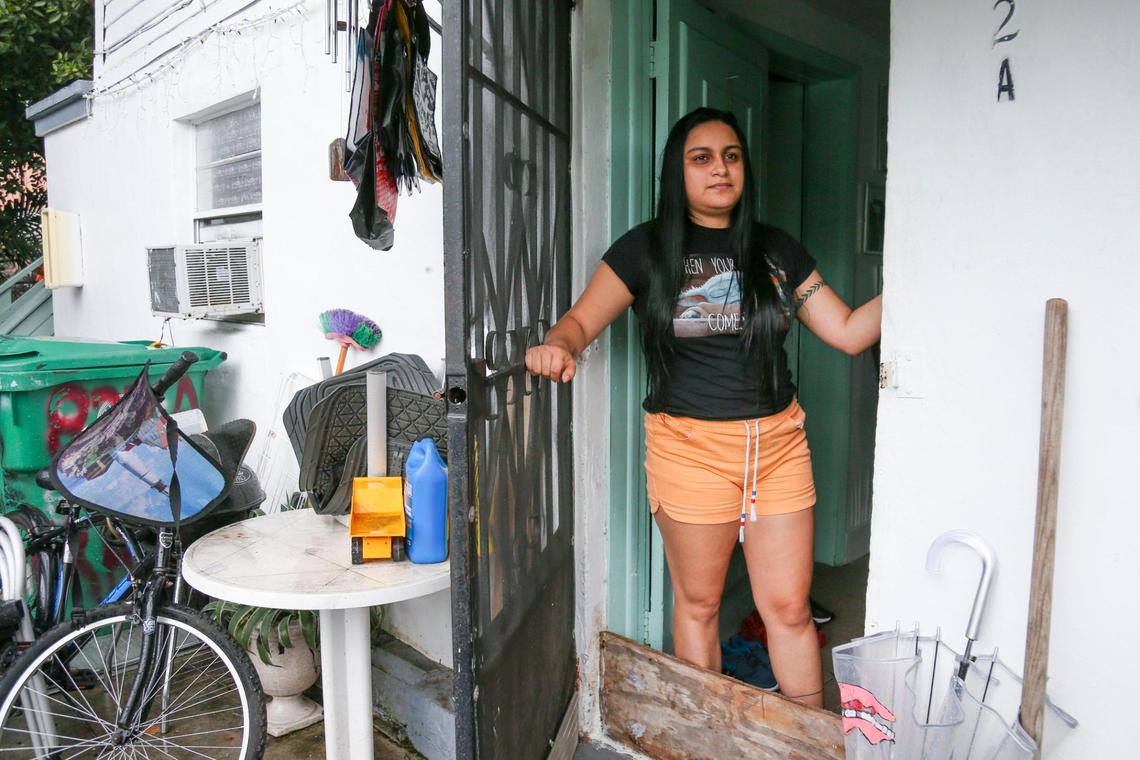 Gabriela Murillo, who lives with her parents on Southwest Third Street, looks on from her front door a week after her rental home flooded due to a weekend of heavy rainfall in the neighborhood of Little Havana in Miami, Florida, on Friday, June 10, 2022.