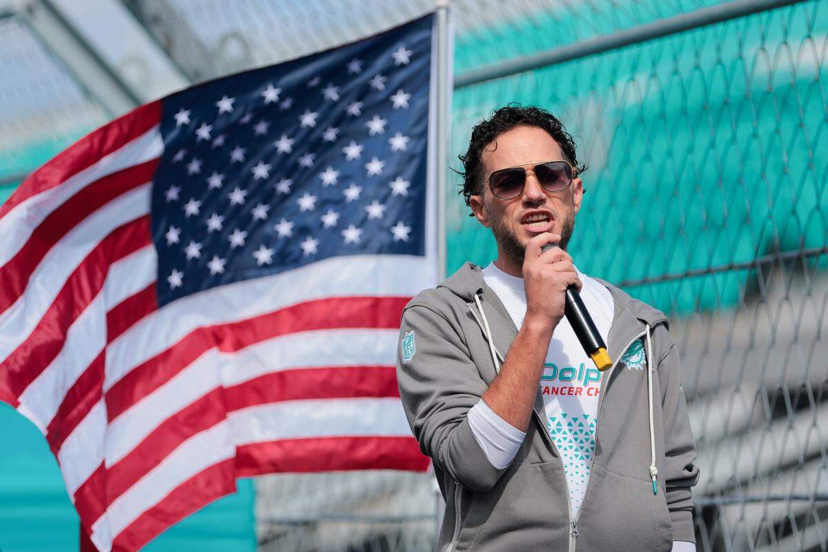Miami Dolphins then-head coach Mike McDaniel talks to the runners participating in the 5k race during the 15th Dolphins Cancer Challenge at Hard Rock Stadium in Miami Gardens, Florida, on Saturday, Feb. 22, 2025.