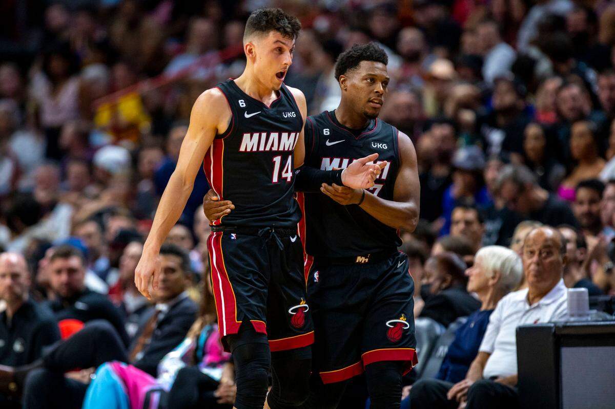 Miami Heat point guard Kye Lowry (7) guides teammate Tyler Herro (14) off the court after an injury during an NBA game against the Golden State Warriors at FTX Arena in Downtown Miami, Florida, on Tuesday, November 1, 2022.