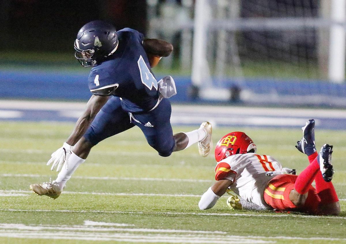 Palmetto Panthers wide receiver Bobby Bussey-Golden (4) jumps over Deerfield Beach Bucks cornerback Hezekhia Masses (8) during the Class A 8 Regional semifinal football game on Thursday, November 18, 2021 Tropical Park Stadium. Andrew Uloza / for THE MIAMI HERALD