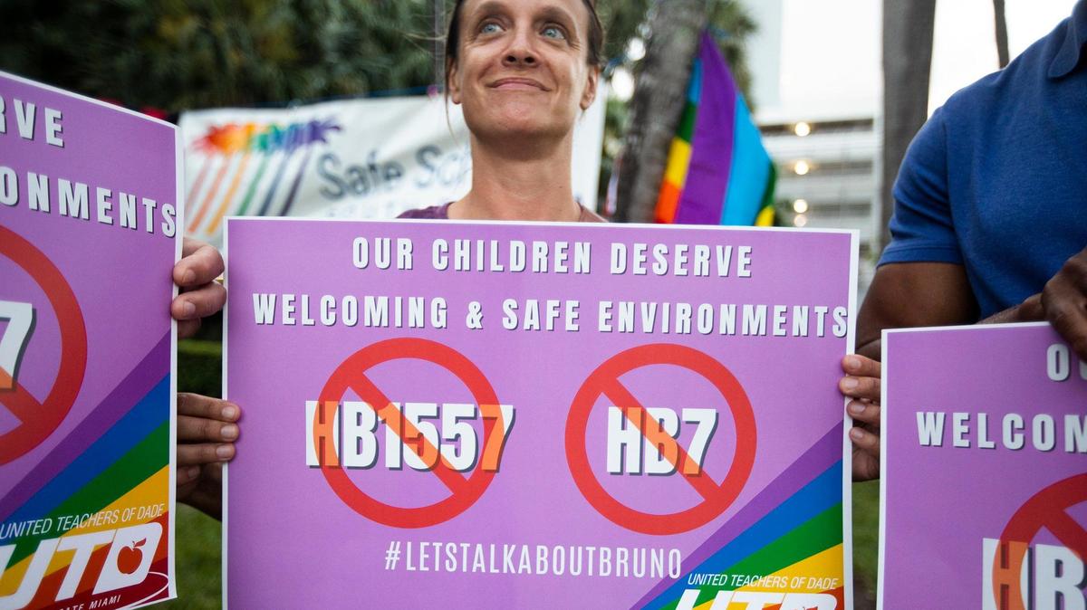 Jessica Lowther holds sign during the Safe Schools South Florida is hosting a rally against ‘Don’t Say Gay’ at Pride Park, Miami Beach on March 1, 2022.