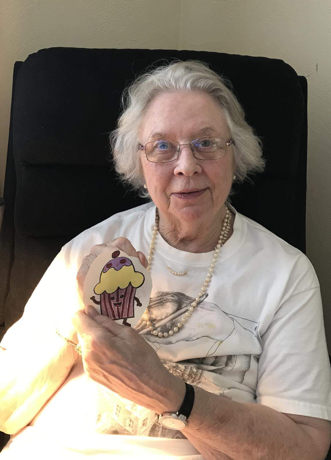 Bay Oaks resident Florence Anderson holds a drawing of a cupcake from a young artist sent to her as part of the Hearts Passion Project to connect seniors and children during the coronavirus pandemic.