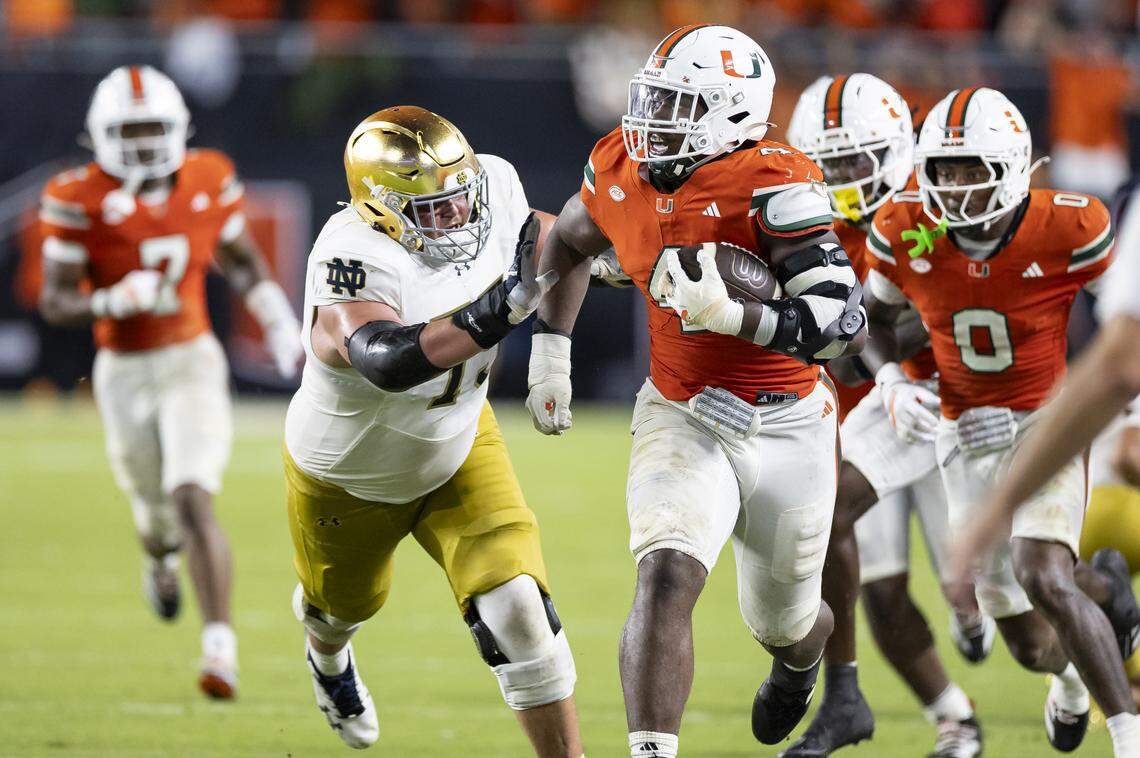 Miami Hurricanes defensive lineman Rueben Bain Jr. (4) runs with the ball after he intercepted the ball against Notre Dame Fighting Irish in the second half of their NCAA football game at Hard Rock Stadium on Sunday, Aug. 31, 2025, in Miami Gardens, Fla.