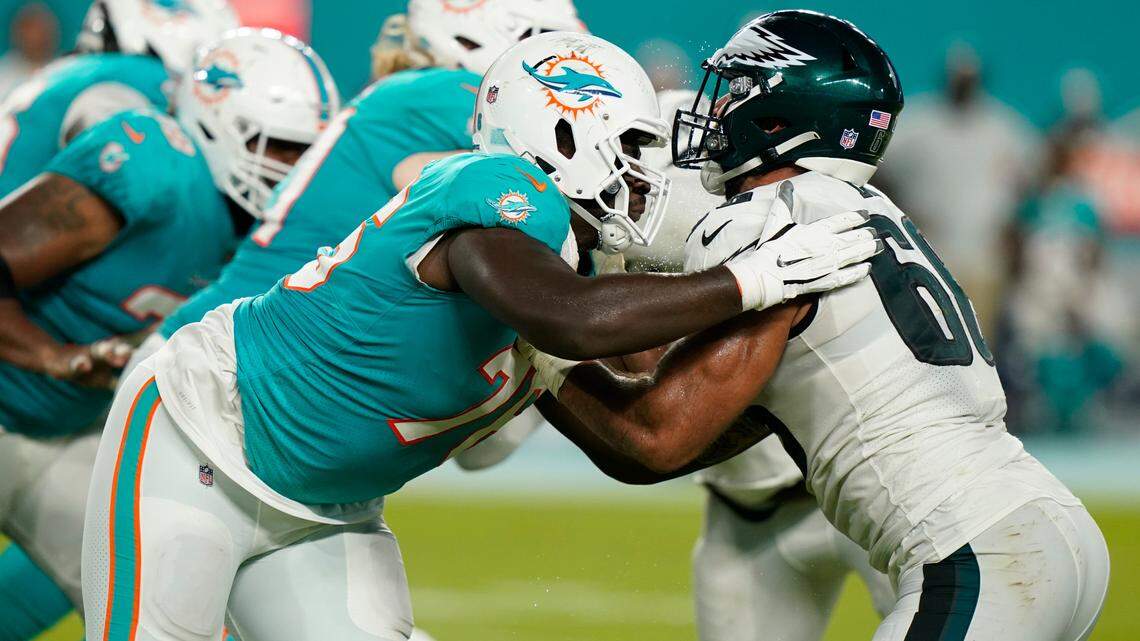 Miami Dolphins offensive tackle Kion Smith, left, and Philadelphia Eagles defensive end Matt Leo, right, are lined up during the second half of a NFL preseason football game, Saturday, Aug. 27, 2022, in Miami Gardens, Fla. 